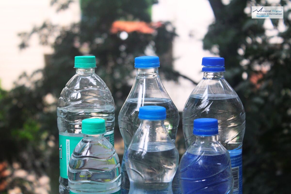 Packaged drinking water plastic bottles with standardized green and blue screw caps standing in a group.screw-on caps, demonstrating uniform bottle cap sizes across brands.